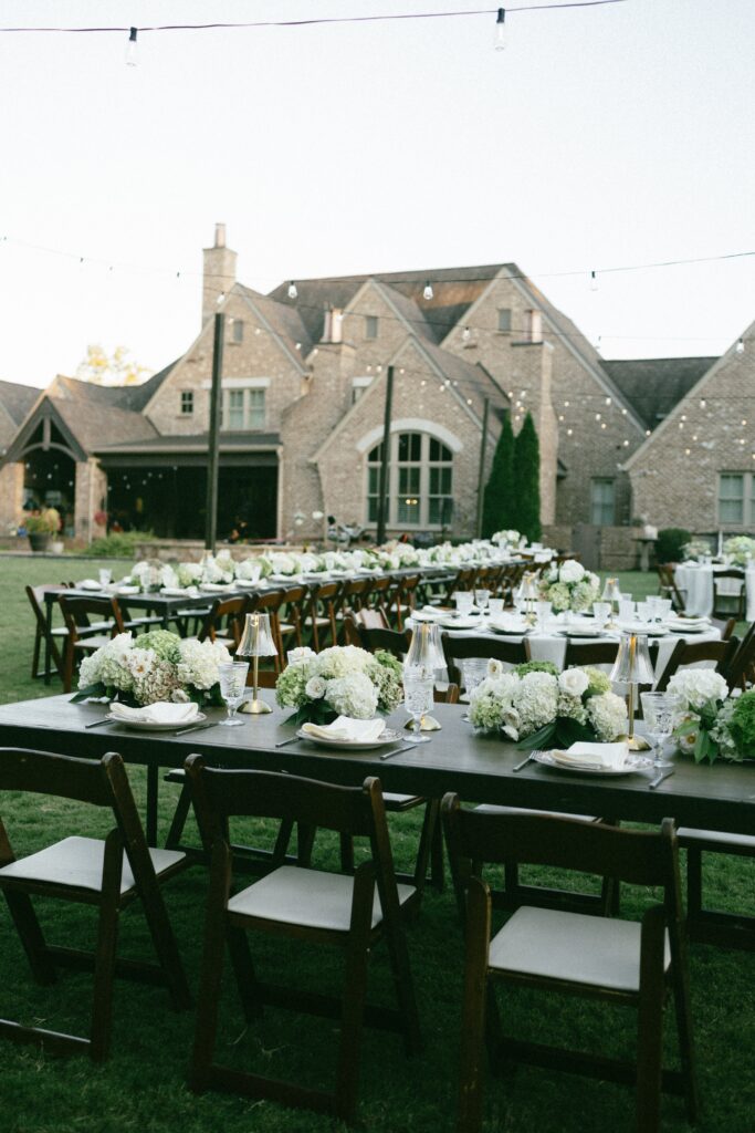 beautiful outdor table setting with flowers and a mansion in the background at a nashville wedding venue