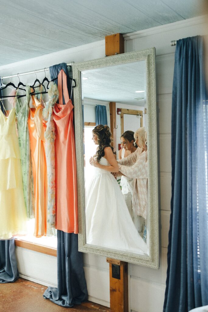 mirror image of a bride getting dressed during her nashville wedding