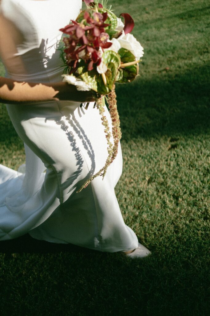 candid photo of a brides lowerbody and flowers during her nashville wedding
