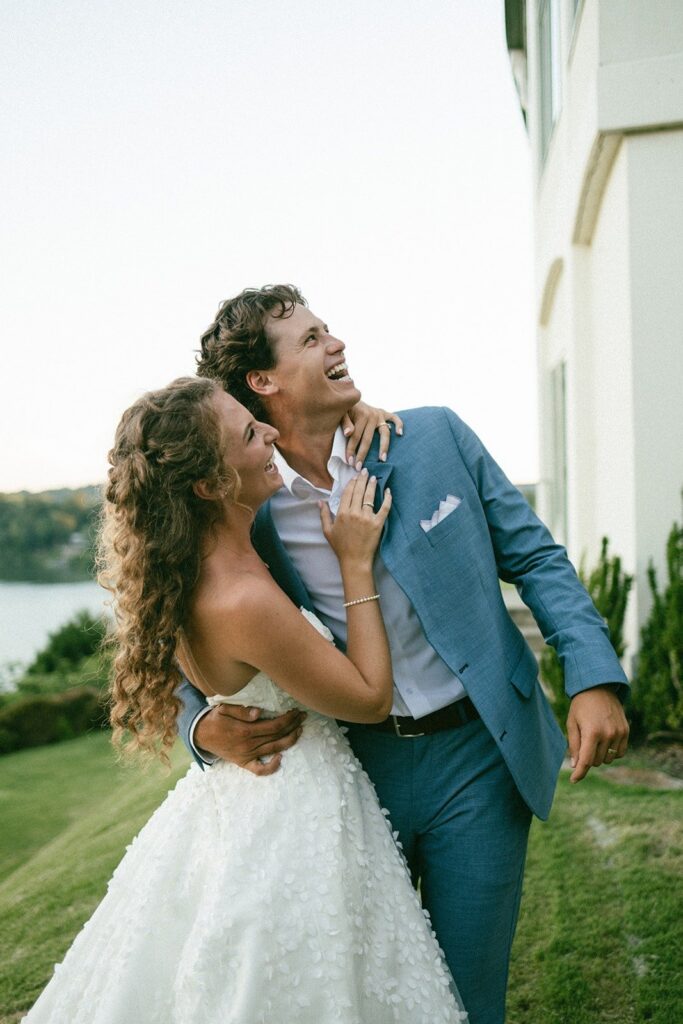 romantic portrait of a newlywed couple celebrating on a hilltop with sweeping views, photographed by one of the top Nashville wedding photographers