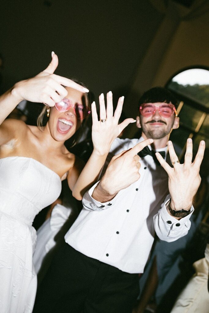 bride and groom showing their wedding rings while celebrating on the dance floor at a nashville wedding reception