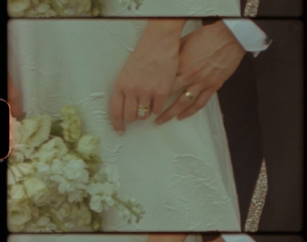 close-up of bride and groom’s hands with wedding rings and white bouquet, captured by a top Nashville wedding photographer