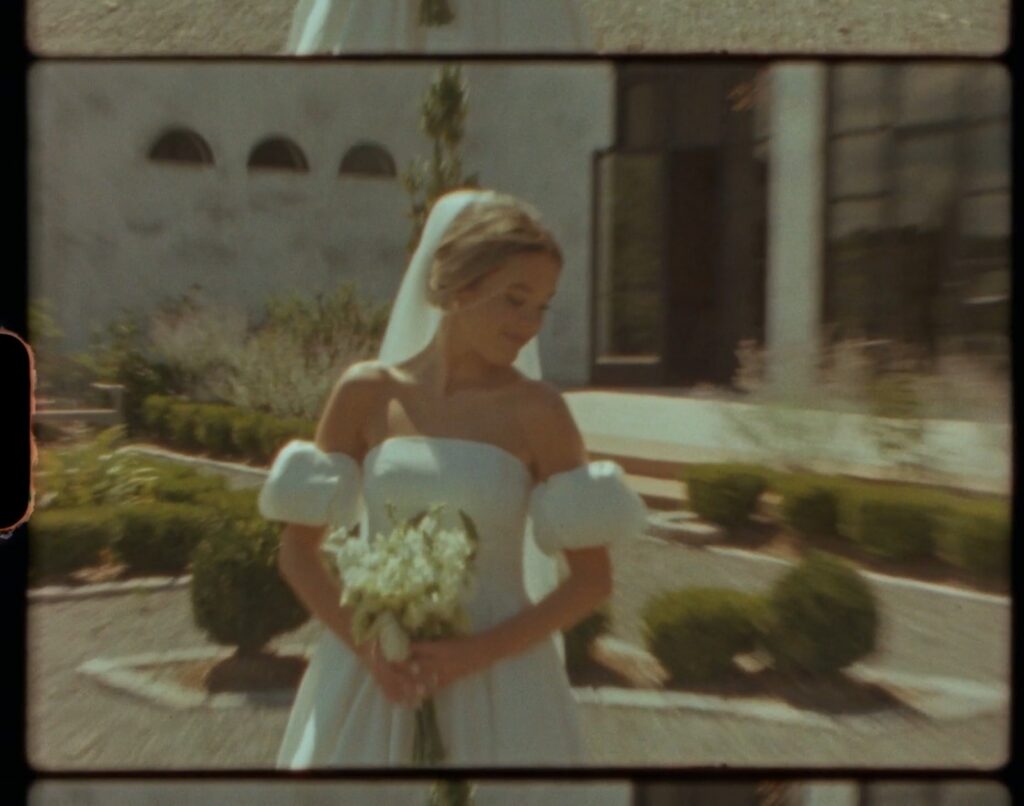 bride portrait holding white bouquet in front of elegant Nashville wedding venue with classic architecture