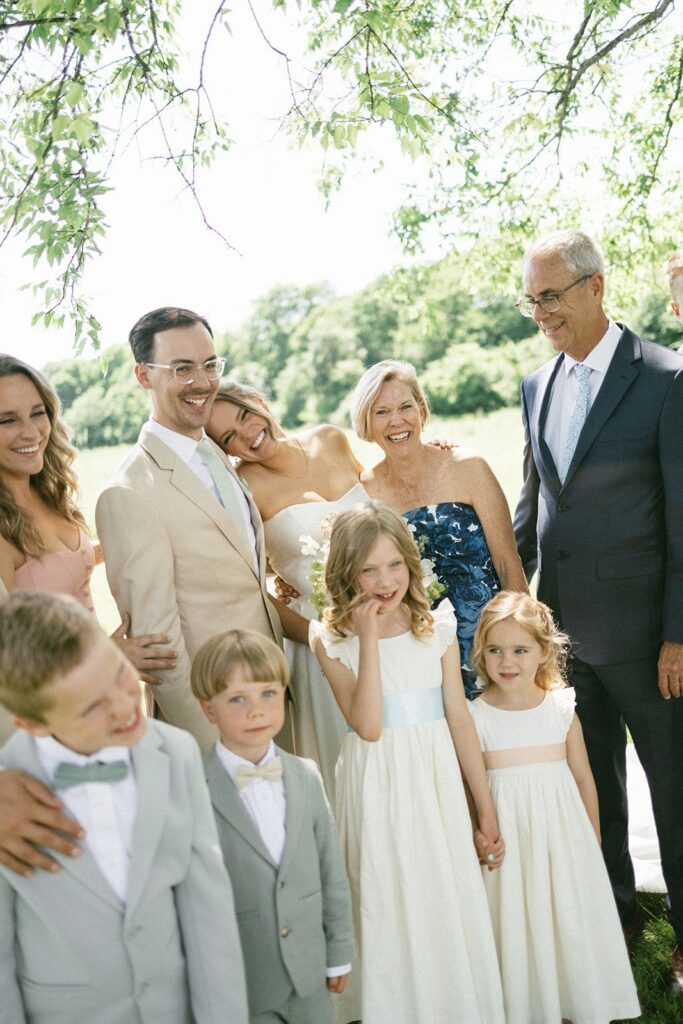 bride and groom smiling with family members during an outdoor celebration captured by a Nashville TN wedding photographer