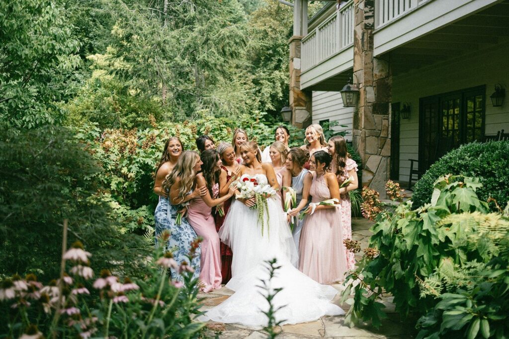 bride surrounded by bridesmaids in a garden setting, captured by wedding photographers in Nashville TN