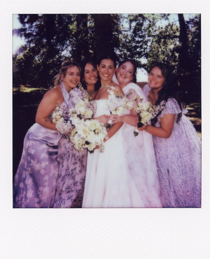 bride and bridesmaids holding white bouquets in a colorful Polaroid portrait by photographers in Nashville Tennessee