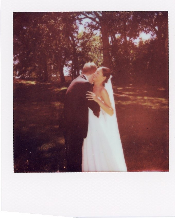 romantic sunset kiss between bride and groom in a dreamy instant photo captured by a Nashville TN wedding photographer