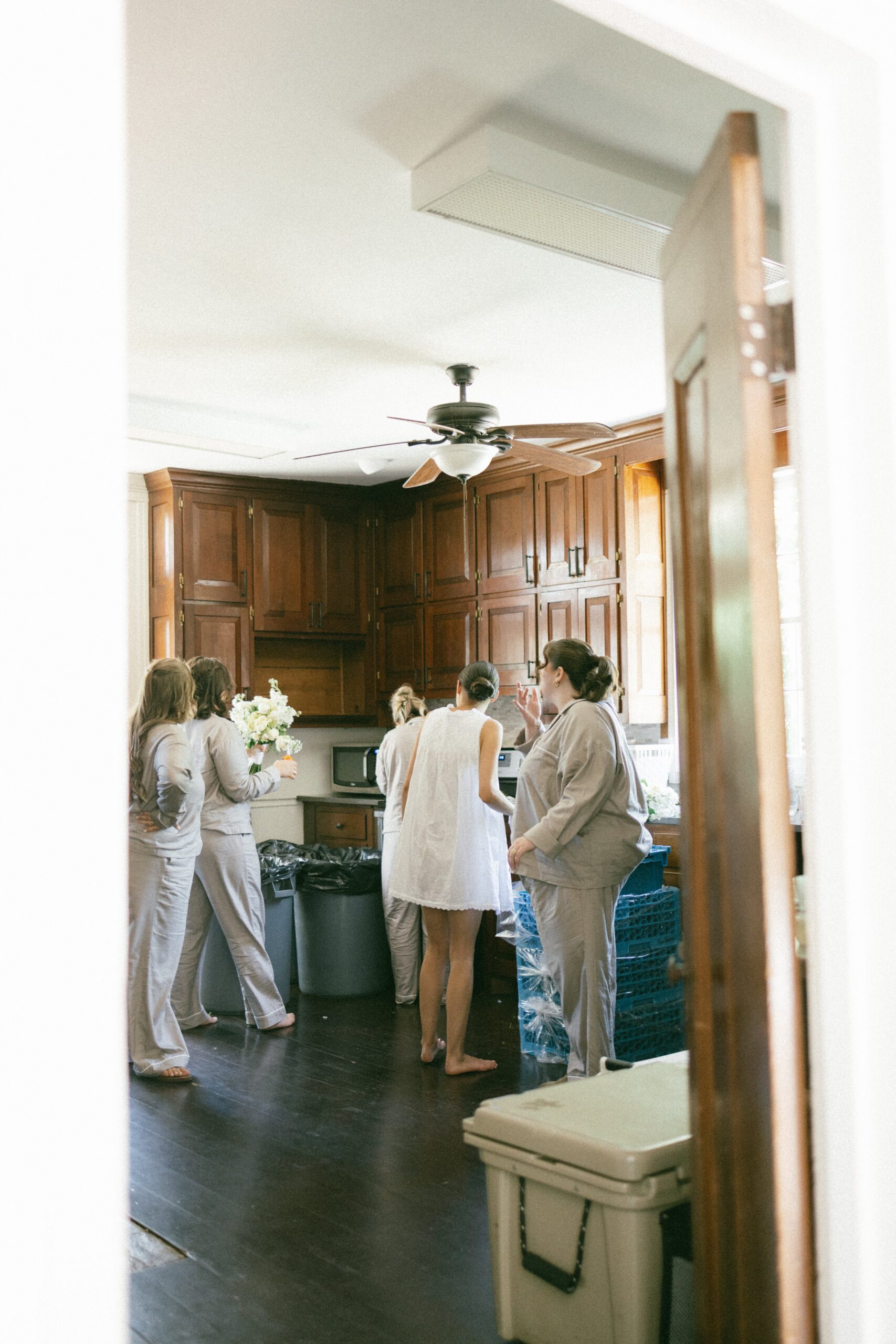 Bridesmaids gathering in a cozy kitchen while getting ready together before a celebration at one of the most welcoming intimate wedding venues in Nashville TN.