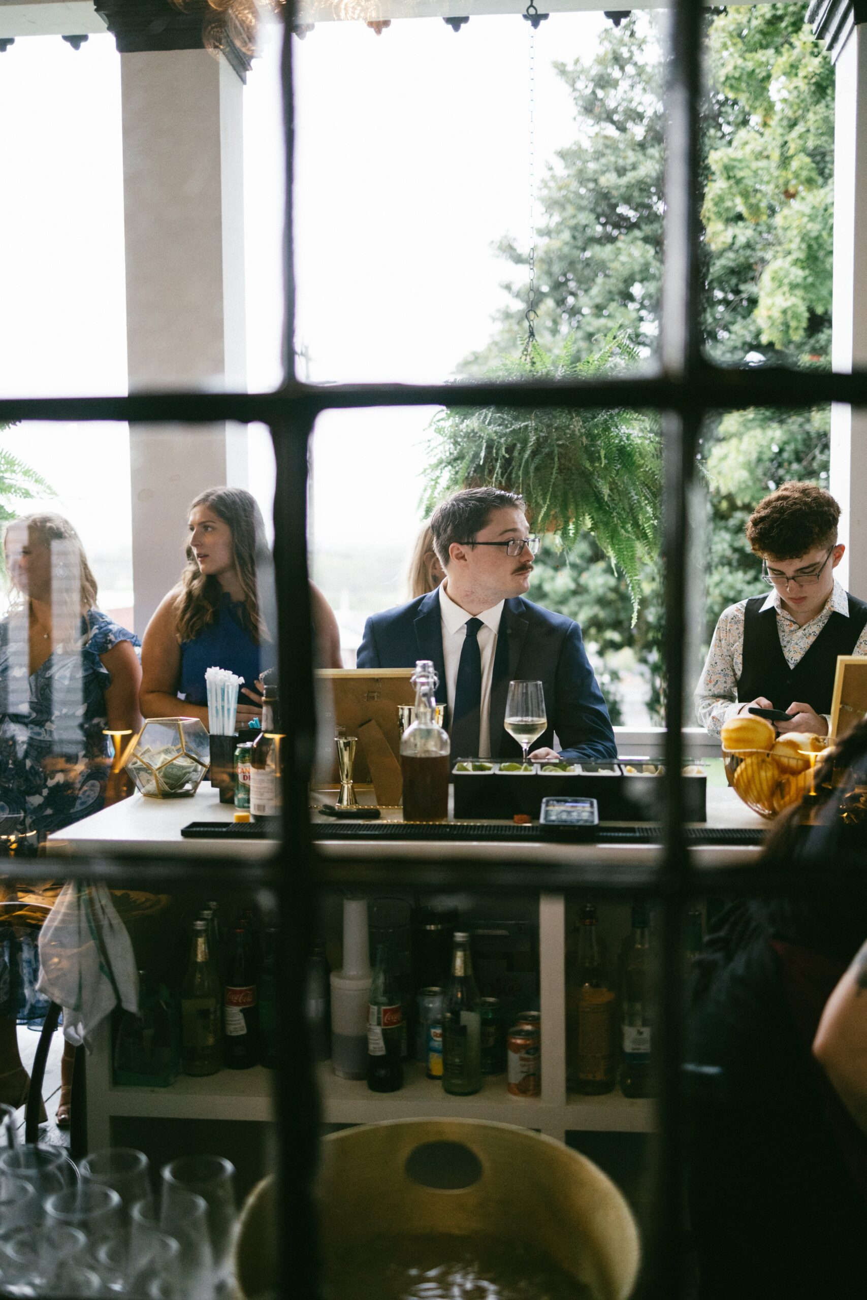 Guests gathering around a stylish cocktail bar during a reception at one of the charming small wedding chapels in Nashville TN.