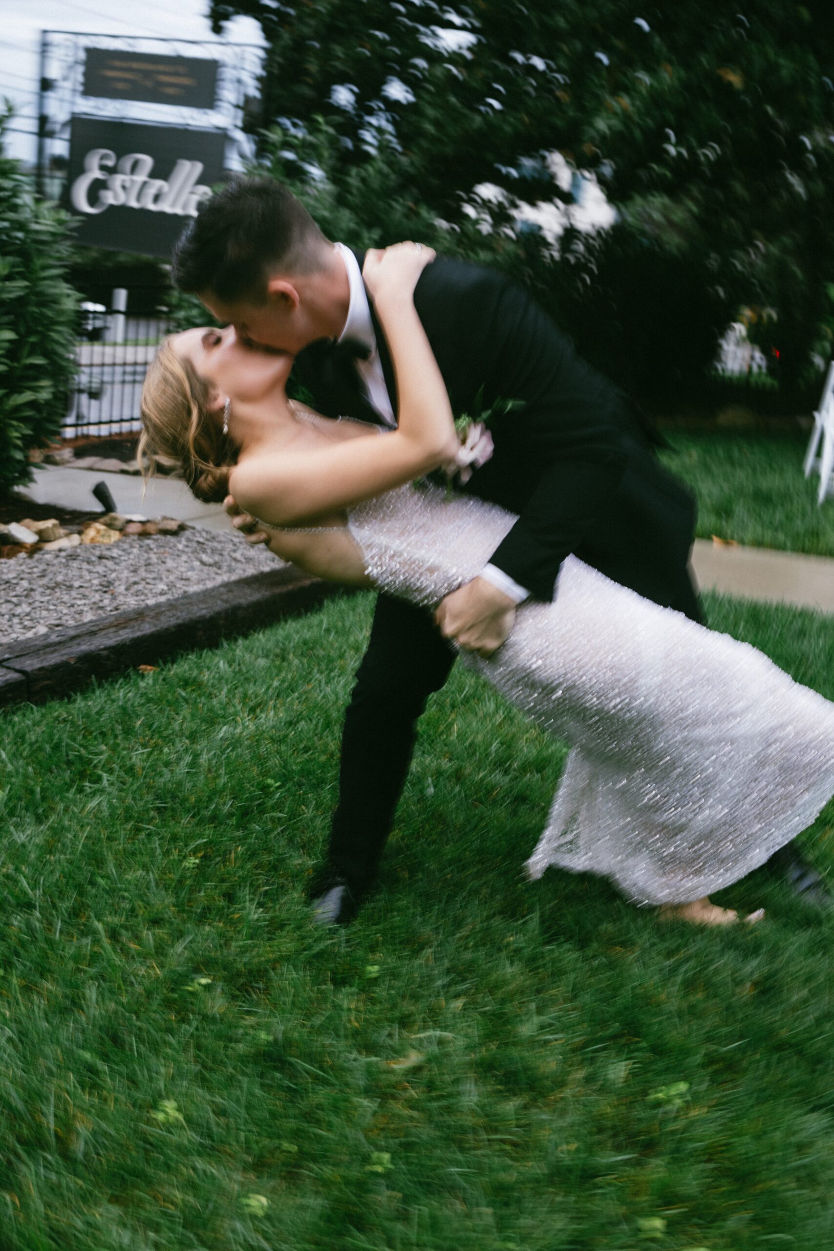 Bride and groom sharing a dramatic dip kiss on the lawn outside Estelle Nashville, one of the most stylish small wedding venues in Nashville TN for intimate celebrations.