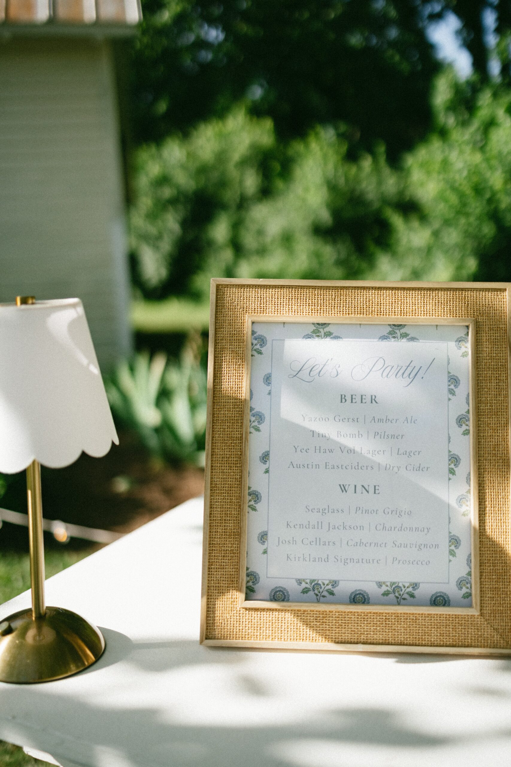Elegant wedding bar menu sign displayed on a reception table during an outdoor celebration at one of the charming small wedding venues Nashville TN couples love.