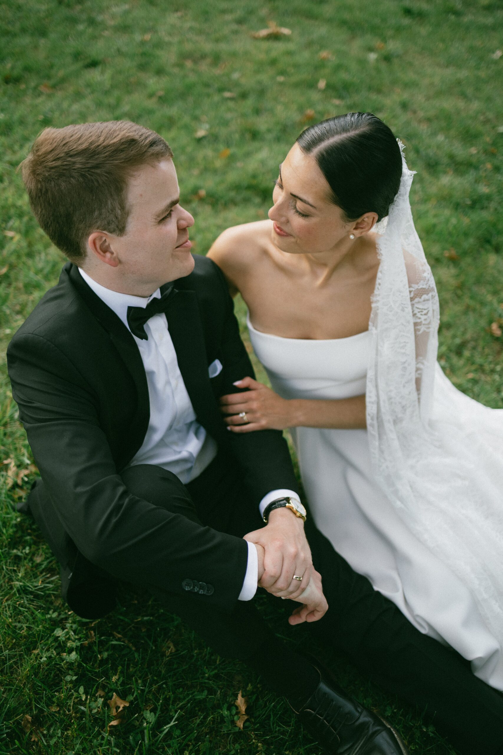 Bride and groom sitting together on the grass sharing a quiet moment during portraits at one of the most romantic small wedding chapels Nashville TN couples choose for intimate celebrations.