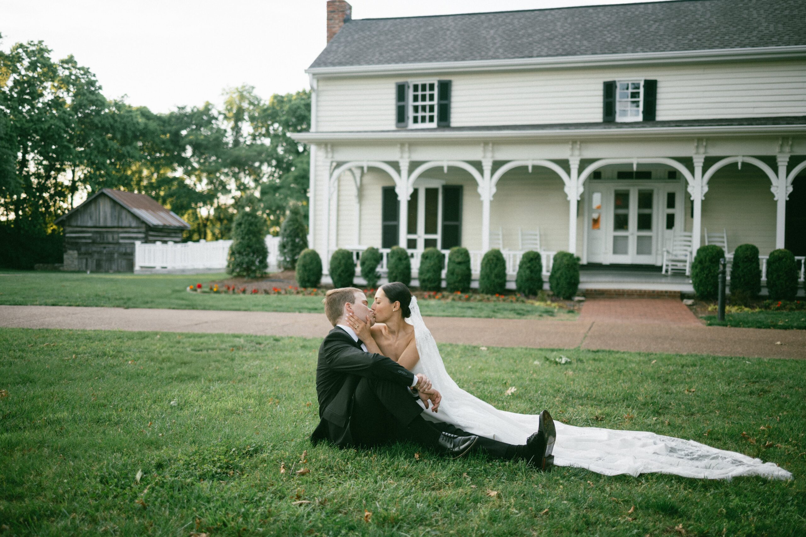Bride and groom sitting together on the grass sharing a quiet moment during portraits at one of the most romantic small wedding chapels Nashville TN couples choose for intimate celebrations.