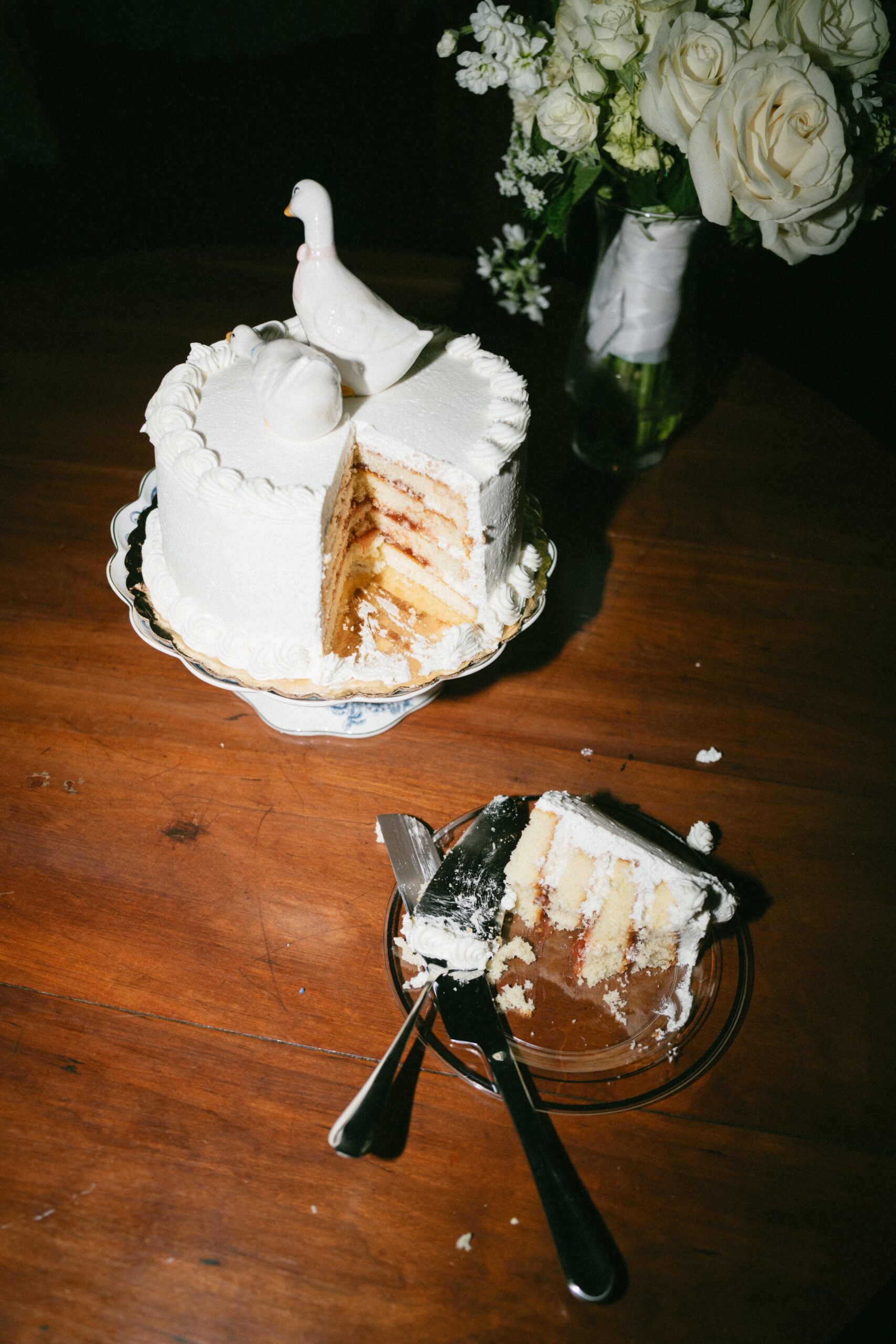 Close-up of a partially sliced wedding cake with a white dove topper served during a celebration at one of the charming small wedding venues near Nashville TN.