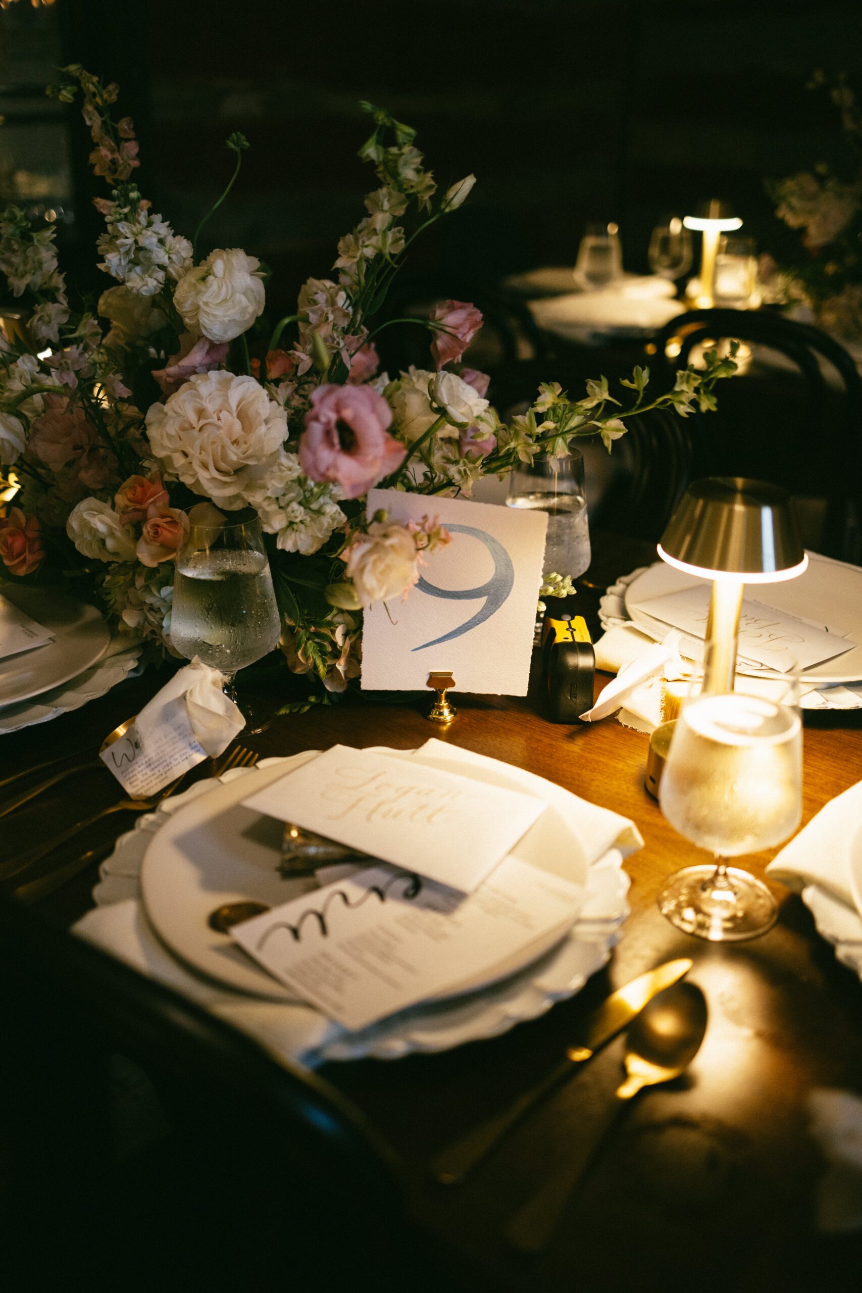 Elegant wedding reception table with floral centerpiece, candlelight, and table number at a small wedding venue in Nashville TN.