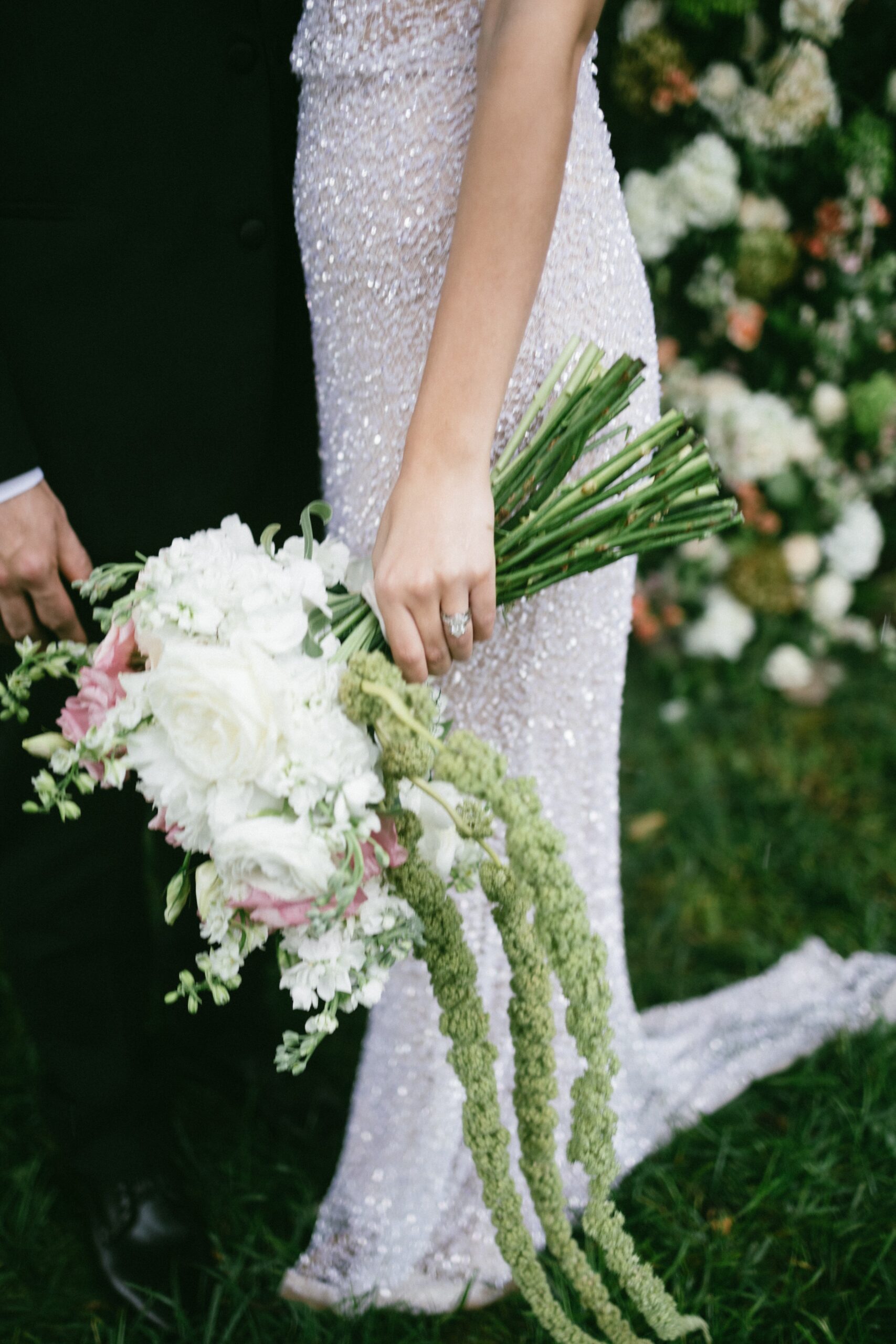 Elegant bride holding a cascading bouquet during portraits at a garden-style small wedding chapel in Nashville TN.