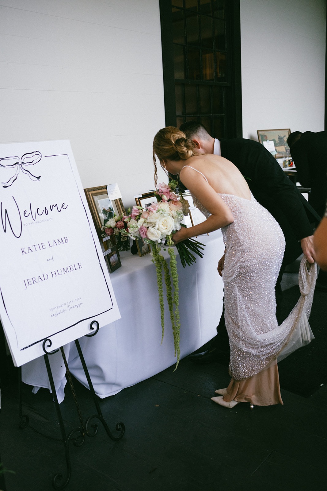bride and groom looking at their welcome table during cocktail hour at the estelle nashville