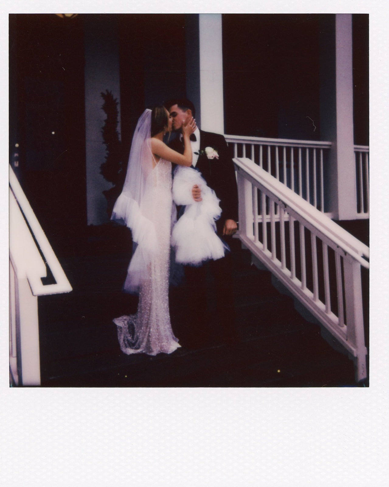 bride and groom kissing on the porch at the estell nashville photo in polaroid