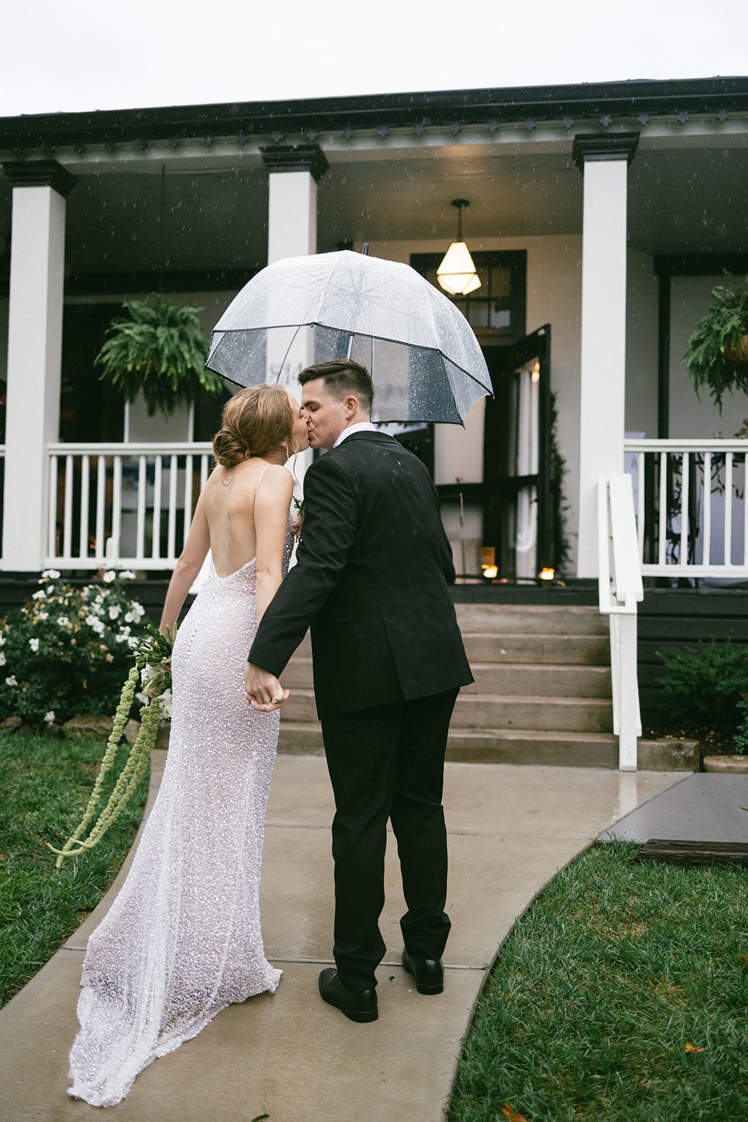 bride and groom sharing a kiss before entering their wedding reception at the estelle nashville