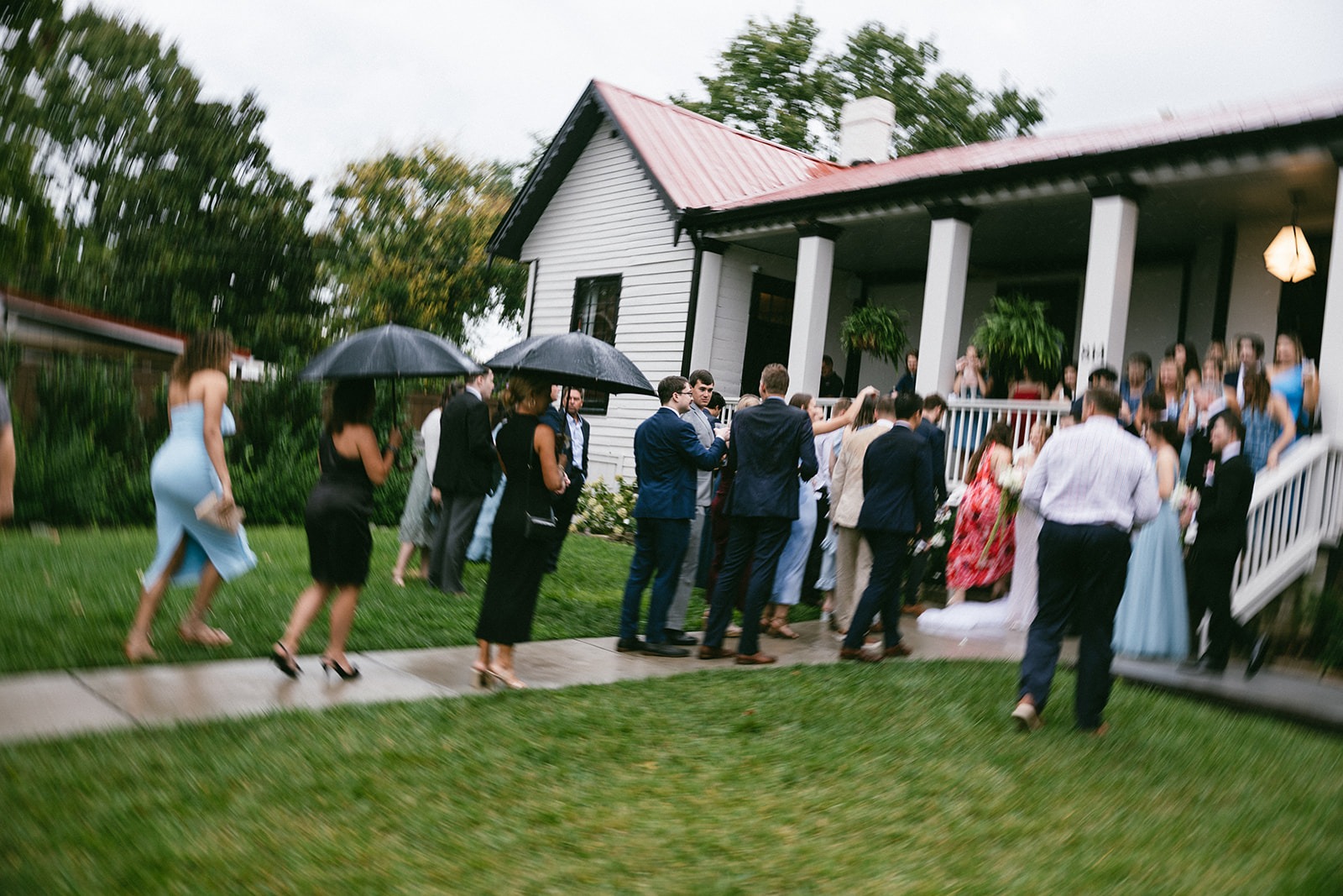 wedding guests moving indoors as it rains softly at the estelle nashville wedding venue