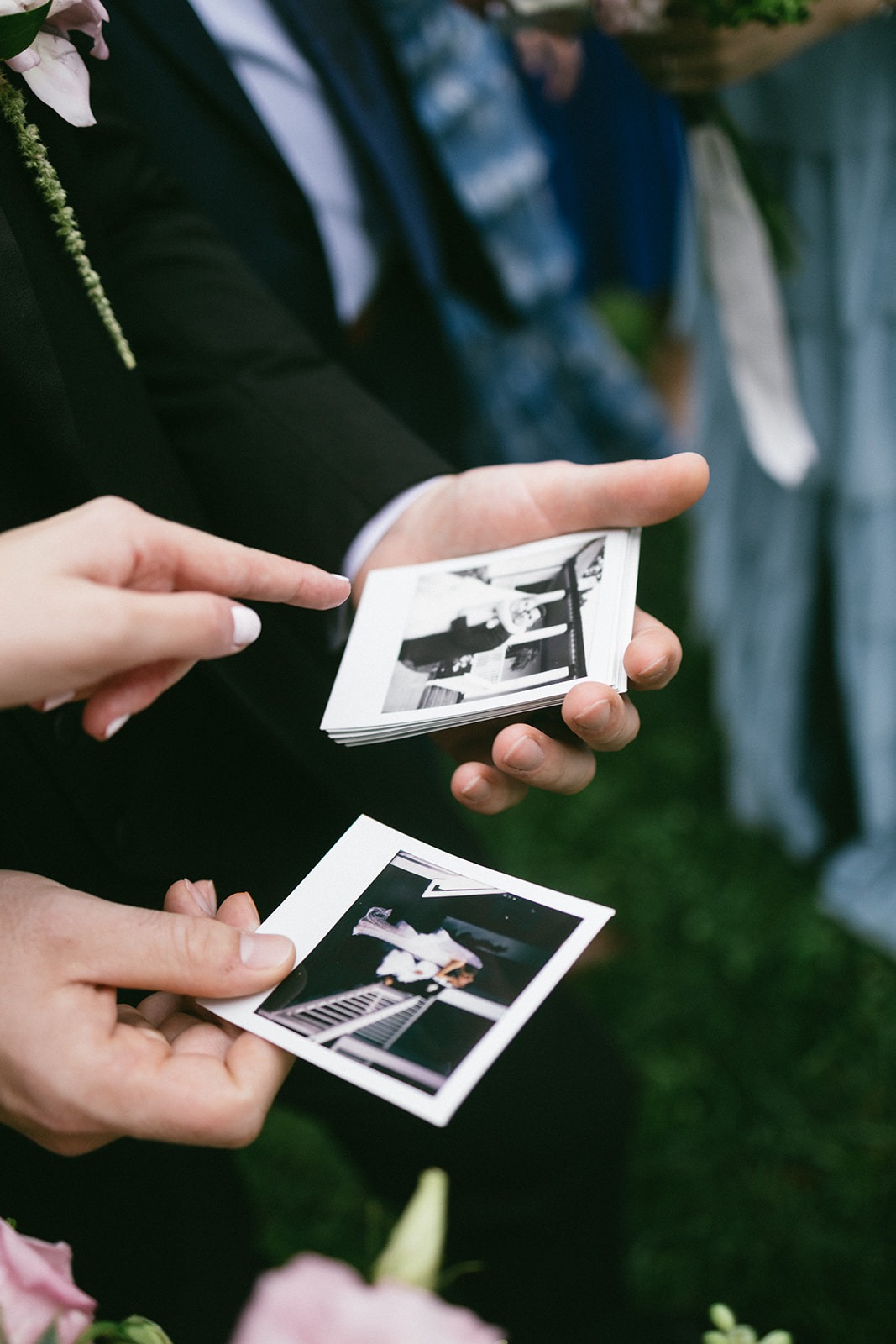bride and groom pointing at pictures during their cocktail hour at the estelle nashville wedding venue