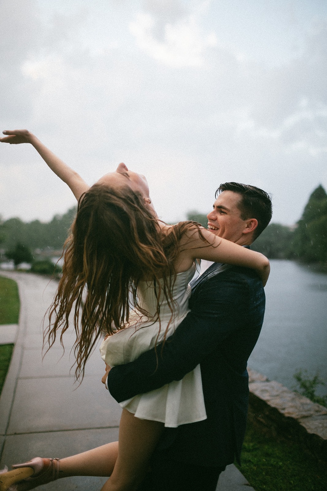 couple having fun in the rain during their engagement photoshoot just before their estelle nashville wedding day