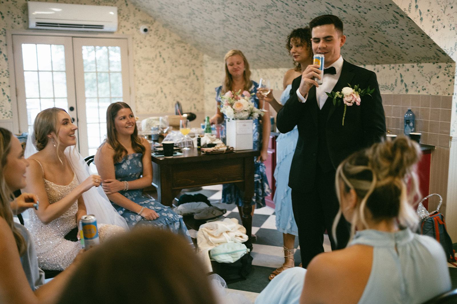 bride and groom sharing a moment with their wedding party at the estelle nashville