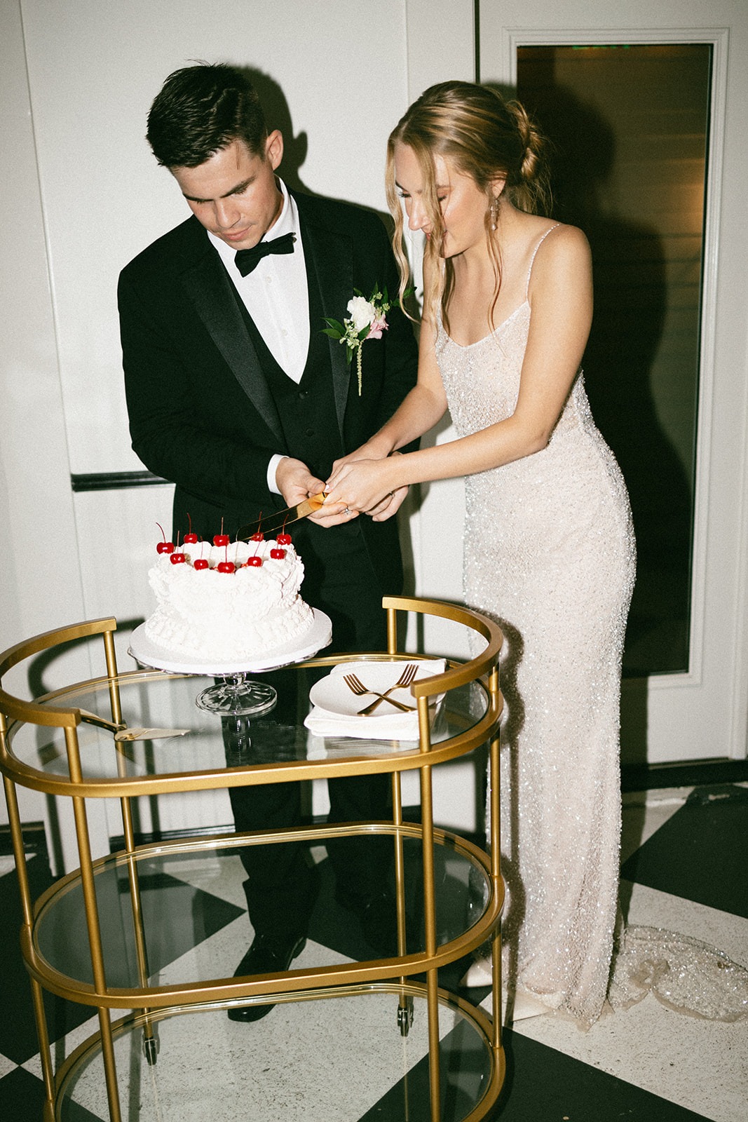 bride and groom cutting their wedding cake during their reception dinner at the estelle venue in nashville