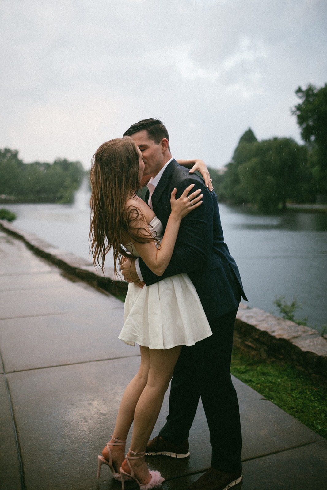 couple kissing in the rain during their engagement photoshoot just before their estelle nashville wedding day