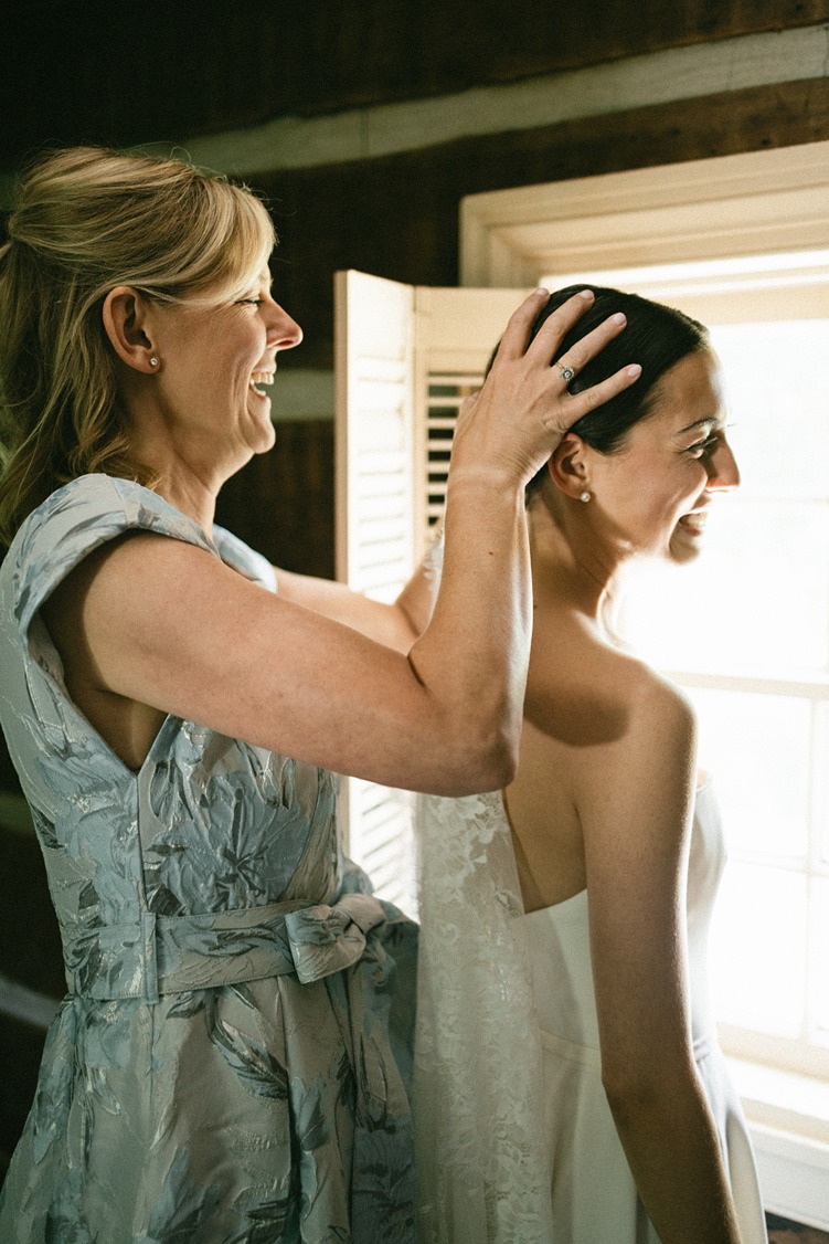 documentary style photography wedding photos of the brides mom helping her get ready
